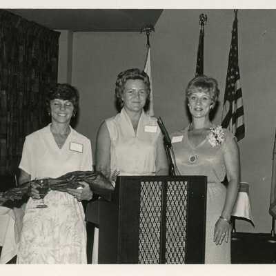 3 Unknown woman standing at a podium