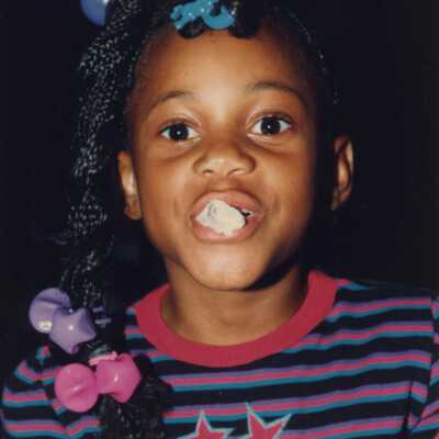 Unknown child with something in her mouth at the Goombay celebration.