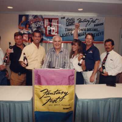 Unknown people at the podium, holding beers.