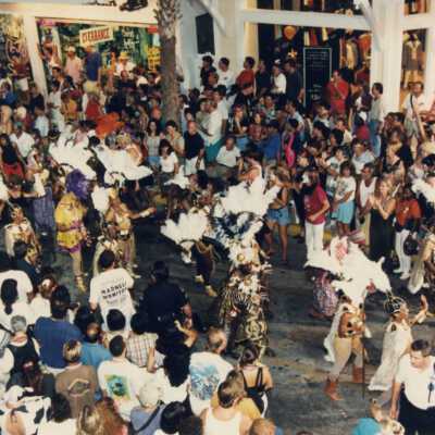 A crowd of unknown people on Duval street near La Conch and the Express store.