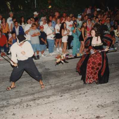 Unknown people dressed up in the street walking in the parade.