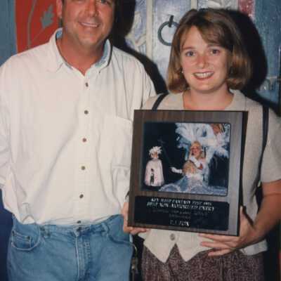 Unknown woman and man with a plaque.