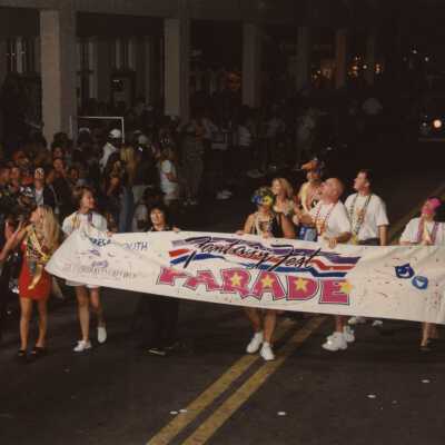Unknown people holding the fantasy fest banner.