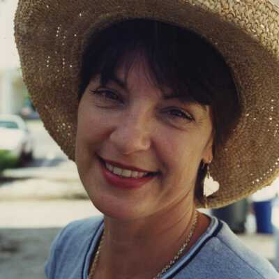 Unknown lady with a hat on.