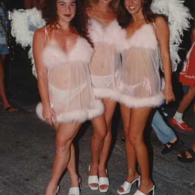 Three unknown woman dressed up.