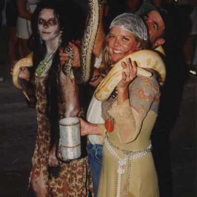 Two unknown people dressed up walking in the parade.