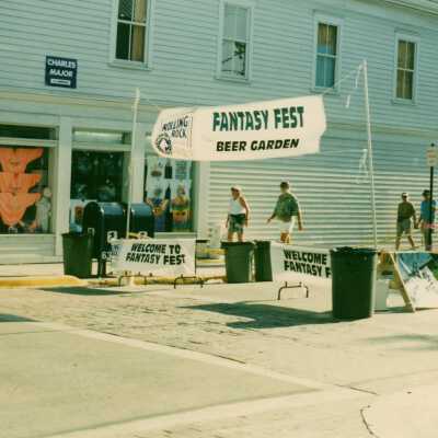 An area on the street set up with a banner that says FF beer garden.