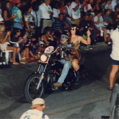 Unknown couple on a motorcycle in the parade.
