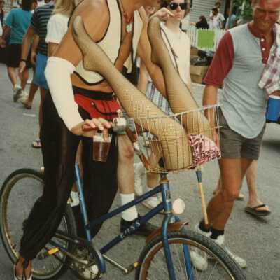 An unknown man dressed up on a bike.