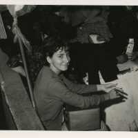 An unknown girl sitting with others around her