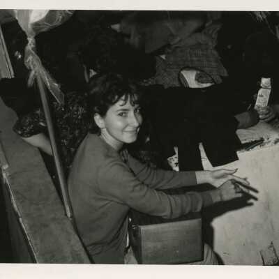An unknown girl sitting with others around her
