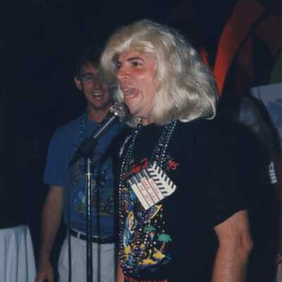 Unknown man talking into a microphone.