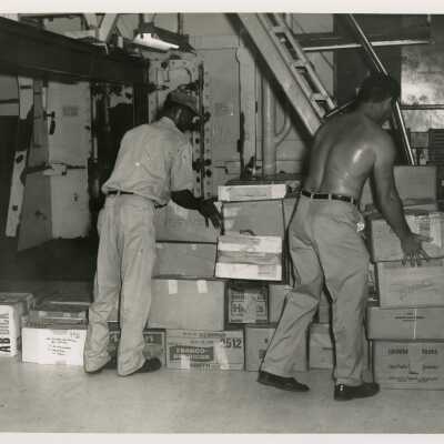 U.S. Navy men moving boxes