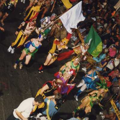 Unknown people dressed up walking in the street for the parade.