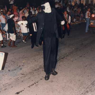 Unknown person dressed up walking down the street during the parade.