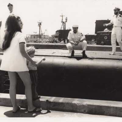 People on a pier near submarines