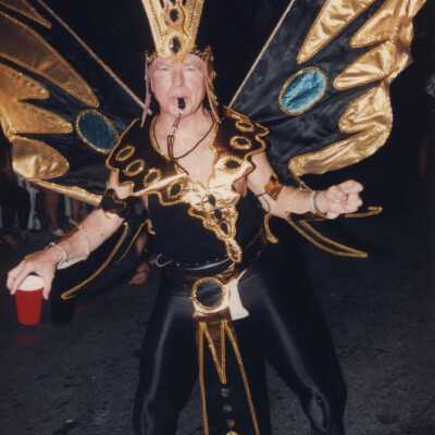 Unknown man dressed up walking in the parade.