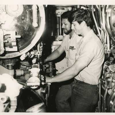 U.S. Navy men in a control room on a ship