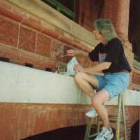An unknown woman working on the terra cotta detail work.