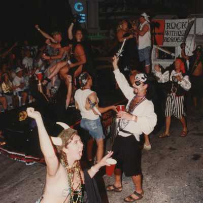 Unknown people dressed up walking in the street for the parade.