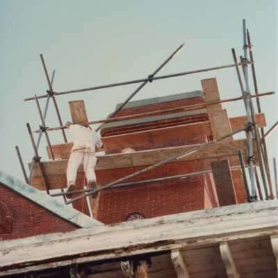 An unknown man working on one of the Chimney's.