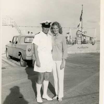 A couple standing outside near a ship