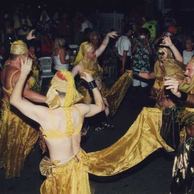 Unknown people dressed up walking in the street for the parade.