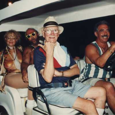 Unknown people in an electric car, one woman has her breast painted.