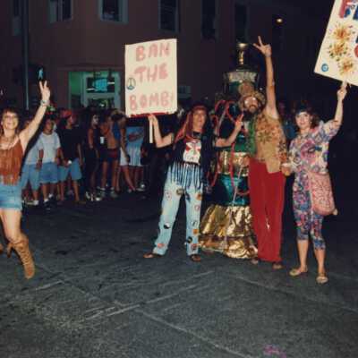 Unknown people dressed up standing on the street.