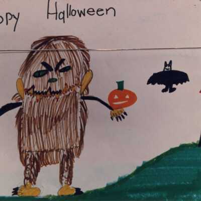 A drawing that a school child did that says Happy Halloween.