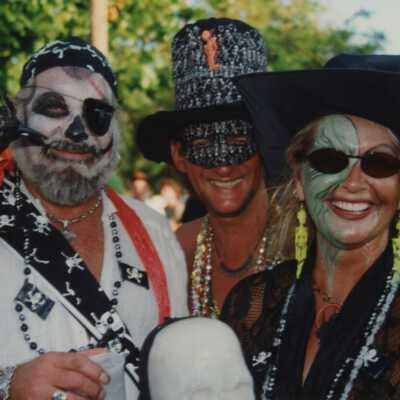 Three unknown people dressed up.