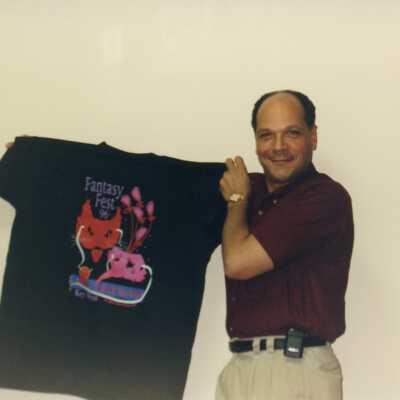 Unknown man holding up an FF shirt.