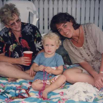 Unknown woman on a blanket with a child.