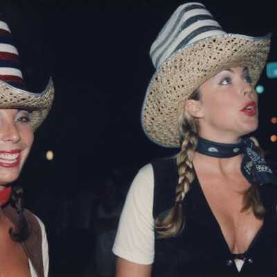 Two unknown woman dressed up.