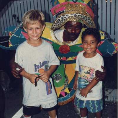 Unknown man dressed up with two unknown kids.