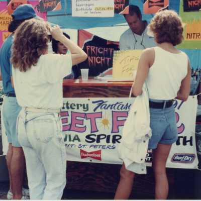 A few unknown people at the Florida lottery street fair booth.