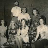 A group of unknown people posing for a photograph