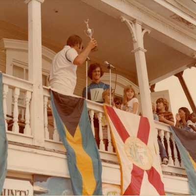 Unknown men and children on a balcony