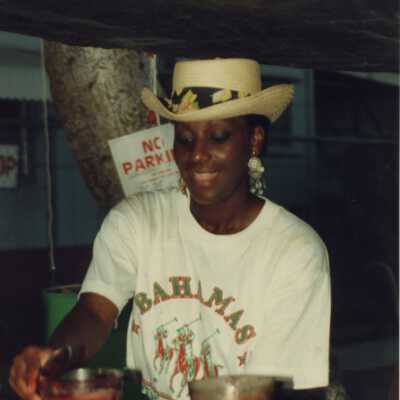 Unknown woman working at a booth at the Goombay celebration.