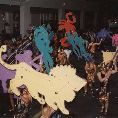 Unknown people dressed up in the street walking in the parade.