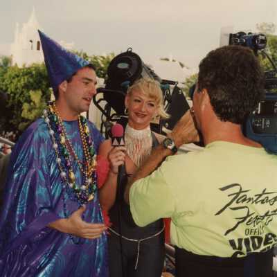 Unknown people dressed up talking with a man that is video tapping them.