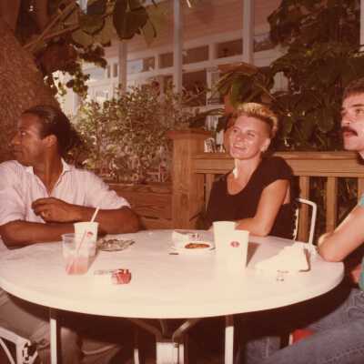 Three unknown people at some sort of FF party.