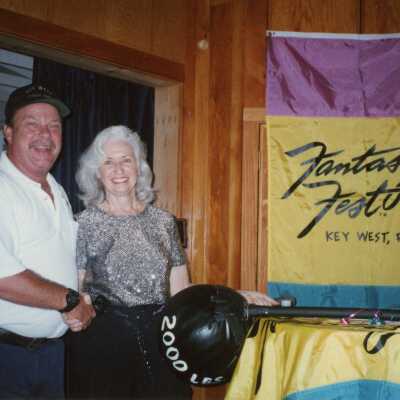 An unknown woman and man at an award ceremony.