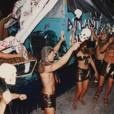 Unknown people dressed up on and off a float.