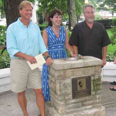 MayMemorial-TheGreatGrandchildren-AfterUnveiling-crp.jpg 528KB: Introductions for Heath Great-Grandchildren, in order of their birth, then will ask each to come up and say a few words:

Bill Bleeker, grandson of May's son Ted Heath (wearing light blue shirt)
"[I] spent the last 52 summers in Saugatuck-- I lived with my cousins Lisa & Jim at Goshorn lake for  many great summers. Worked at Wersma blueberry farms till I was 16 then worked at Clearbrook CC for the next 7summers and also was a life guard at the Oval for 8 years. Moved to Aspen co in 1983 after having way too many drinks with  Al Pendorf at Wallys. Have been there ever since and married the love of my life Barbara in 1990. We are both in the Ski industry. We have a small cattle ranch just outside Aspen and own the Captain George P Crawford house on Captains row on Griffith street in Saugatuck.( which we of course named Heathcote ) I am the longest residing citizen of Saugatuck 1835--- 175 years and still going strong."

Grandchildren of May's Daughter Gladys Barron
Jim Barron Diaz
"Entered the world about the same time that his great grandma May Heath was leaving it, so we are both celebrating a 50th anniversary this year. Spent all his summers as a youth in Saugatuck, cranking the Ferry across the river for tips and going to Oxbow School of Art. Currently lives in Lafayette, CA with his wife, Ramona, and two kids, Ray and Ava. Co-Founder of Affine Systems, an online video ad technology company in San Francisco, CA."

Lisa Diaz Nash
""Lisa Diaz Nash is so happy to be back in Saugatuck, where she, her brother, Jim, and cousin Bill spent so many wonderful summers growing up.
"After college, Lisa went off to Hong Kong and Taiwan to study Mandarin Chinese, work as a tour guide in China and see the world.  She wound up working for American Express in Asia for 9 years, where she married her husband, Michael, and had their first daughter, Sarah.  They moved back to the States in 1989 and, after a year in NY/NJ, moved out to the San Francisco Bay Area, where they've lived ever since.  Their second daughter, Mary (named after Mary Elizabeth Peckham Morrison of Saugatuck renowned), was born in 1992.  Lisa has held several senior marketing positions with major consumer brand companies as well as start ups.  For the past three years, she has led Blue Planet Network, www.blueplanetnetwork.org, a non-profit that raises awareness and funds for safe drinking water projects throughout the developing world."