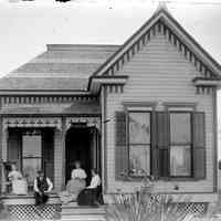          Deam12.jpg 826KB; Four adults on the front porch of a house with ornate woodwork and shingle details. This image was featured as History Mystery #22 with the text: This History Mystery remains unsolved.
   