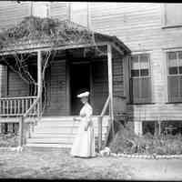          Deam14.jpg 972KB; A woman standing in front of wooden house. 
According to Jack Sheridan 