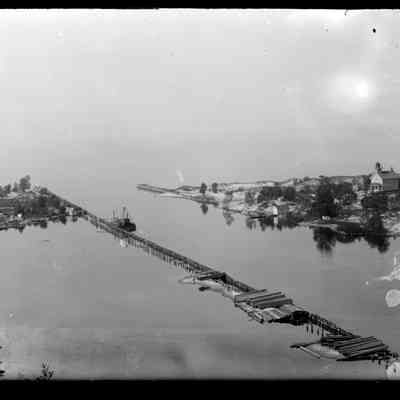 Deam25.jpg 634KB: The original mouth of the Kalamazoo with channel walls and the Saugatuck light. According to Jack Sheridan "Old Harbor view taken from dune to the south. The obvious explanation for the materials on the pilings and the barge/dredge is that the new cut piers were being constructed at that time. Note that the channel to the west is filling with sand."