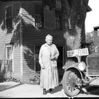          hmbButler&MaryBillingsWoman.jpg 280KB; ca 1910. The photo depicts a mature woman standing next to a model T style car and a sign that says 