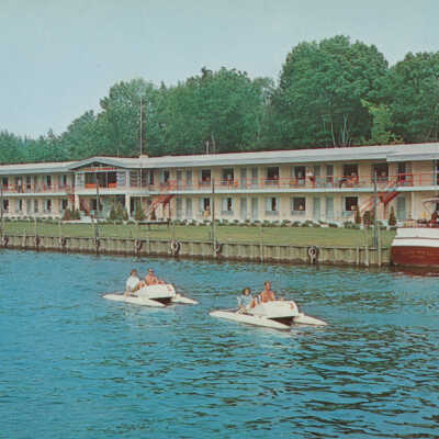 1004V Water Skeeters paddling in front of Ship and Shore Boatel: 56241-B copyright 1962, L.L. Cook Co., Milwaukee